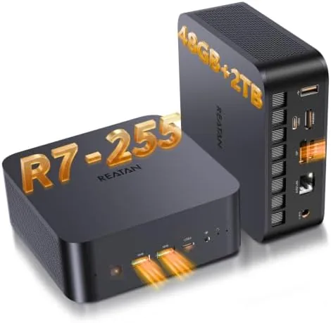 The Reatan X7 mini PC on a desk next to a monitor