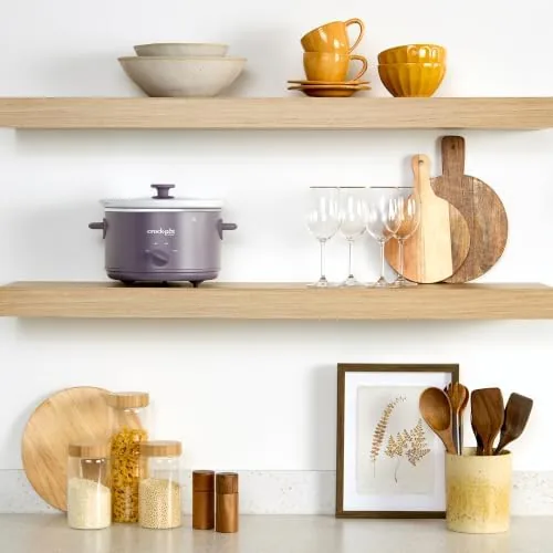 The stoneware insert and glass lid placed in a dishwasher rack after use