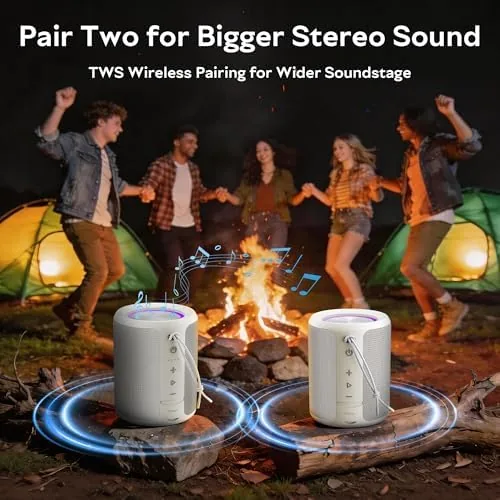 The gray speaker playing on a patio during a summer evening