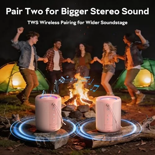 The pink speaker playing outdoors next to a towel and bag