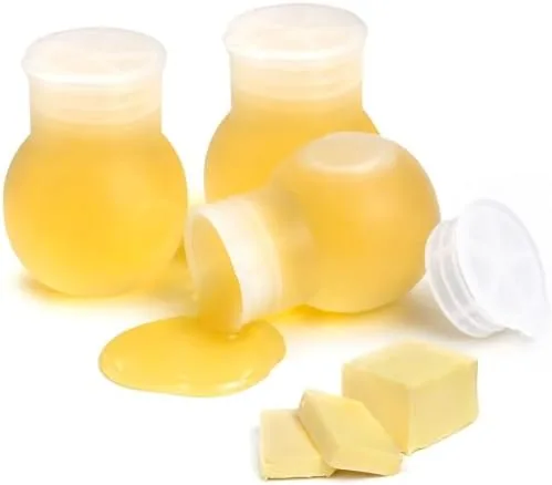 Three silicone butter melting pots in a row with their lids beside them on a kitchen counter