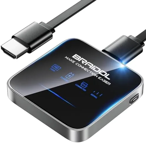 The black wireless HDMI dongle held beside an HDMI port for scale