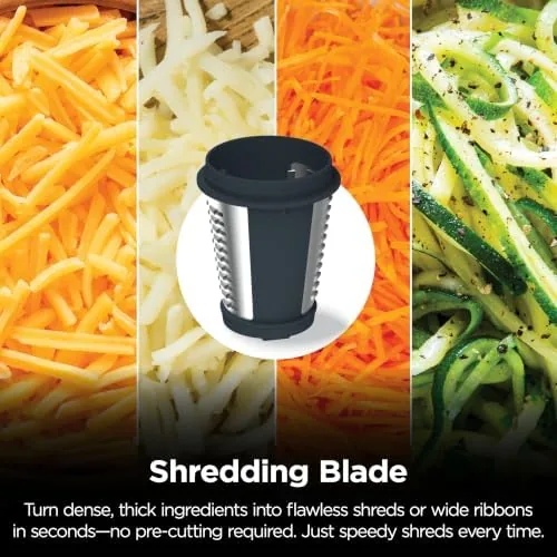 The slicing and shredding discs attached to the machine beside prepped vegetables