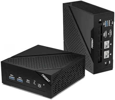 The AM02 mini gaming PC sitting on a desk next to a monitor