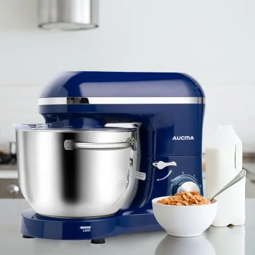 A finished loaf of bread on a cooling rack next to the mixer