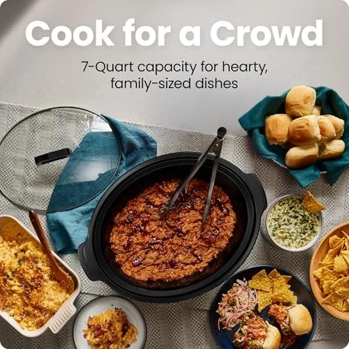 The slow cooker filled with a pot roast with vegetables in the crock